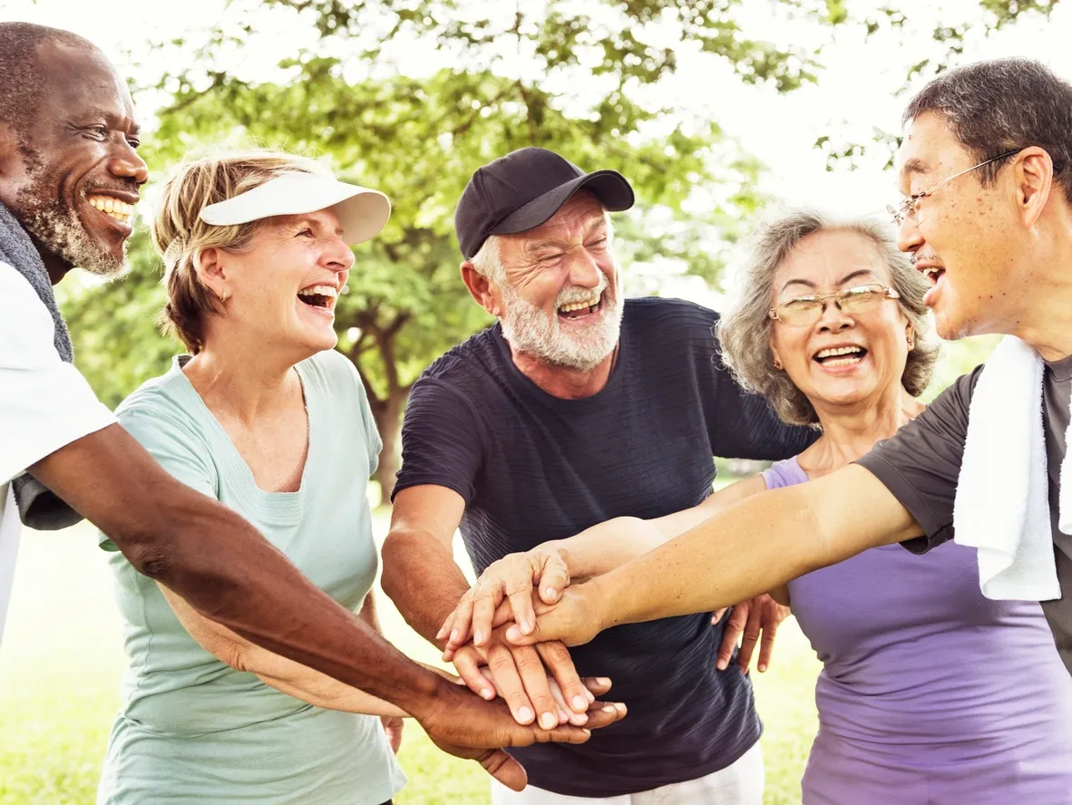 A group of people standing around each other.